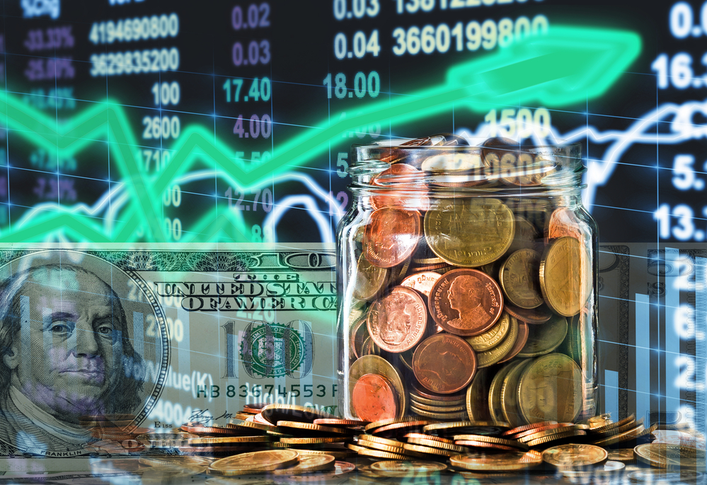Jar of coins and bill in front of investment board